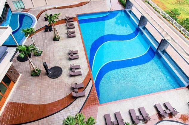 Aerial view of the curved swimming pool and surrounding deck