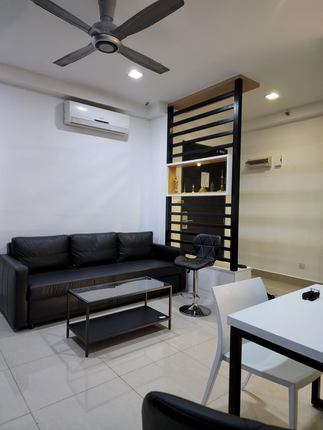Living area with sofa, coffee table and slatted room divider